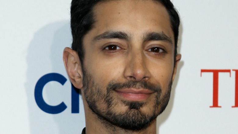 Riz Ahmed smiling slightly