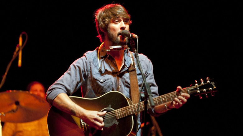 Ryan Bingham playing acoustic guitar