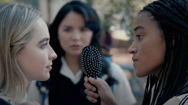 Amandla Stenberg holding a brush in front of Sabrina Carpenter on the set of 'The Hate U Give'