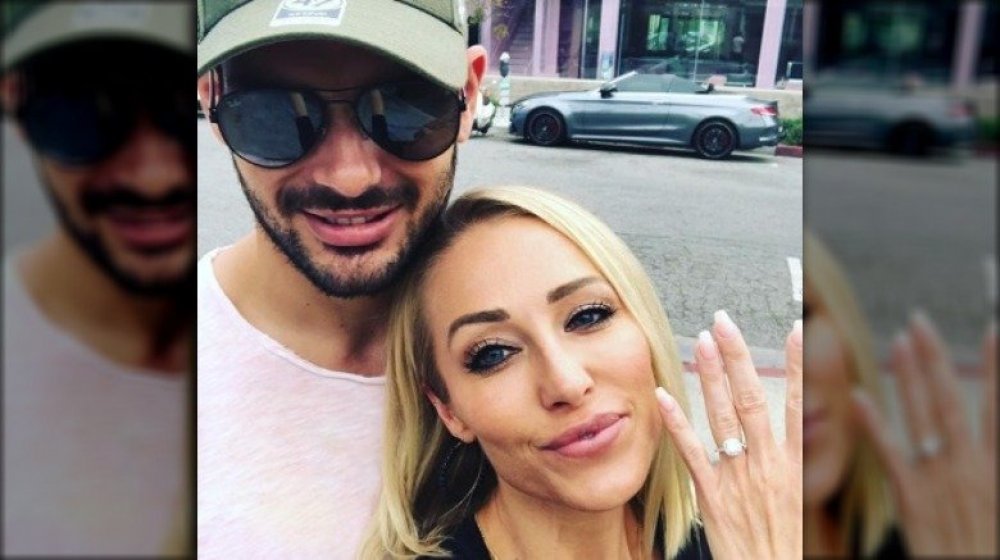 Romain Bonnet and Mary Fitzgerald smiling in a selfie while showing off her engagement ring