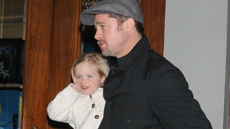 Shiloh Jolie-Pitt carried by Brad Pitt