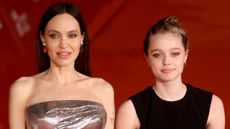 Angelina Jolie, Shiloh Jolie-Pitt smiling on a red carpet