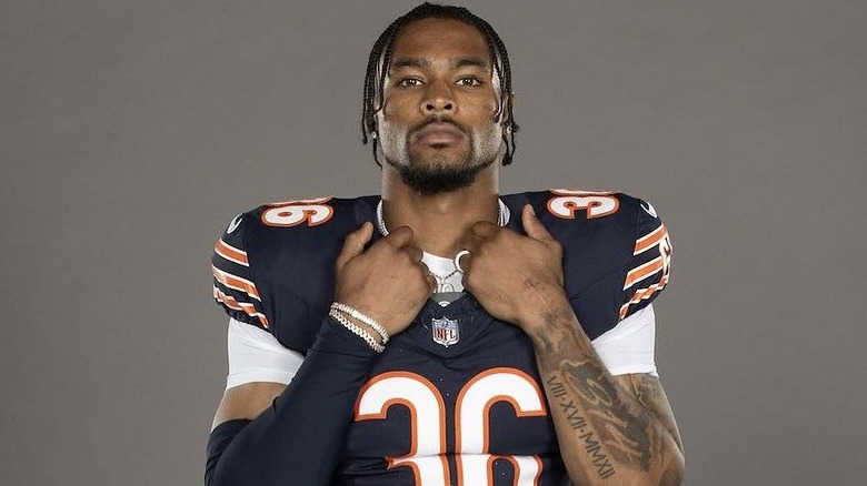 Jonathan Owens wearing a blue and orange Chicago Bears jersey and pads