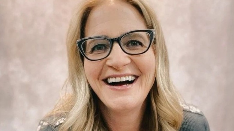 Christine Brown with glasses on, smiling