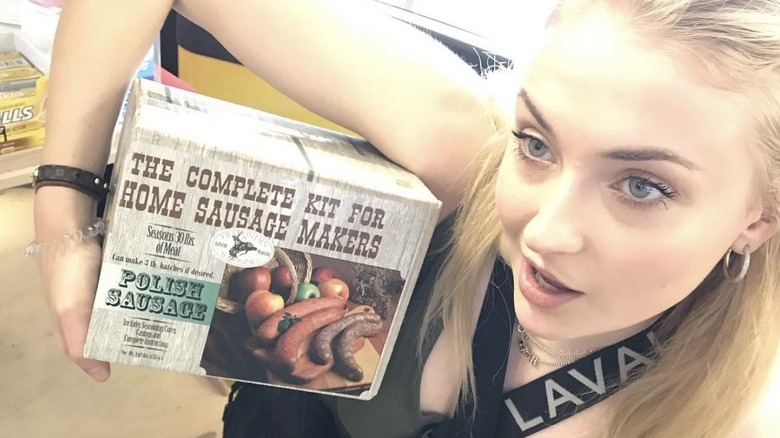 Sophie Turner holding sausages