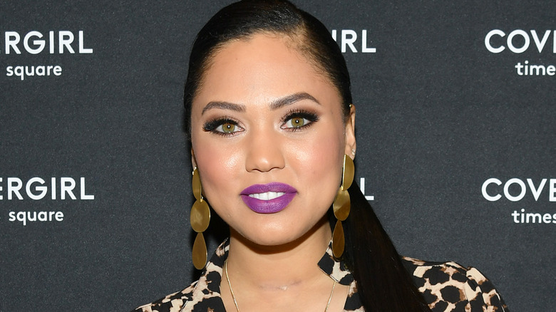 Ayesha Curry smiling, purple lipstick