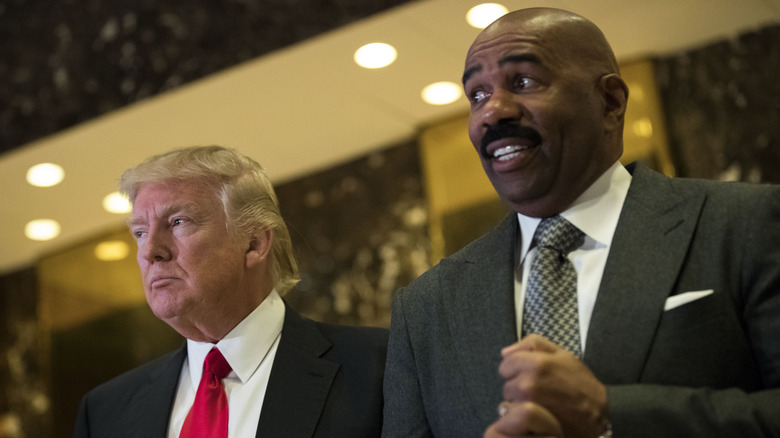 Donald Trump and Steve Harvey standing together, Steve looking uncomfortable