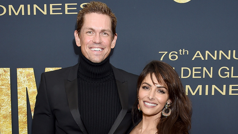 Steve Howey and Sarah Shahi smiling