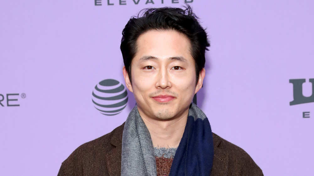 Steven Yeun smirking at the Minari premiere