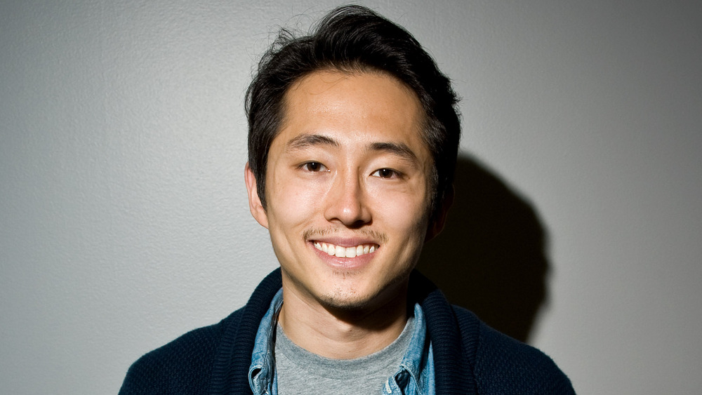 Steven Yeun smiling at a comic expo