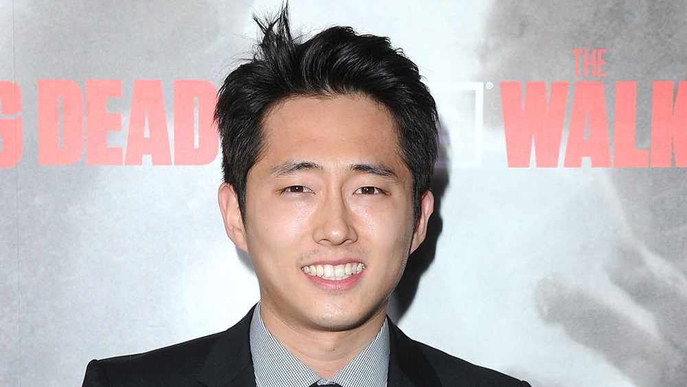 Steven Yeun smiling at The Walking Dead premiere