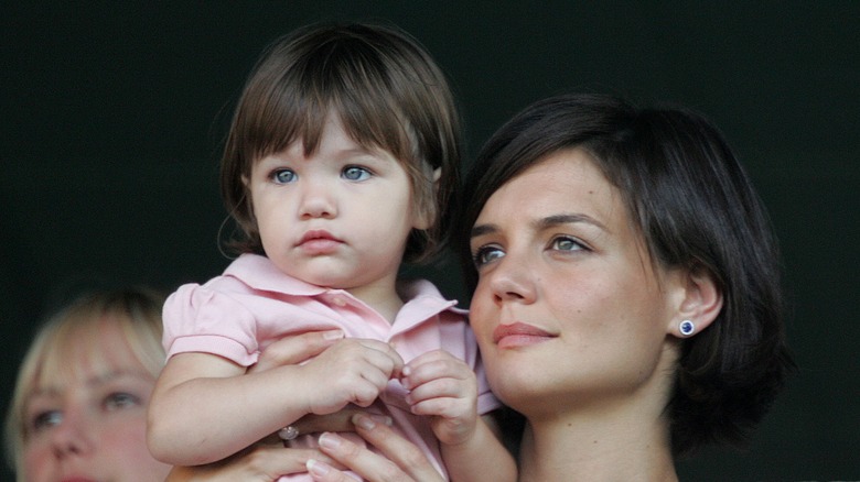 Katie Holmes holding Suri Cruise up