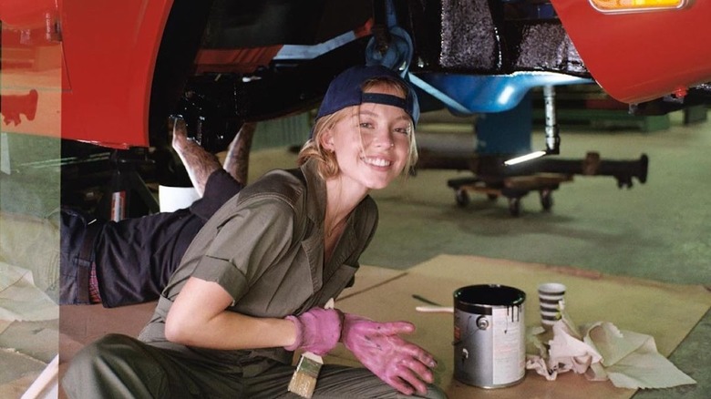 Sydney Sweeney working on a car