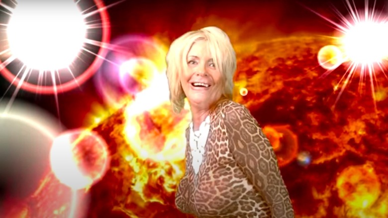 Tan Mom dancing in front of green-screened sun