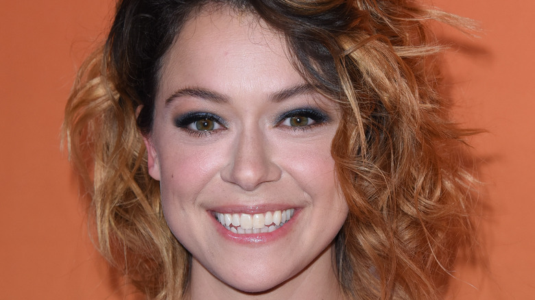 Tatiana Maslany smiling with messy hair