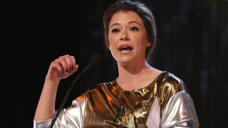 Tatiana Maslany talking in silver and gold outfit