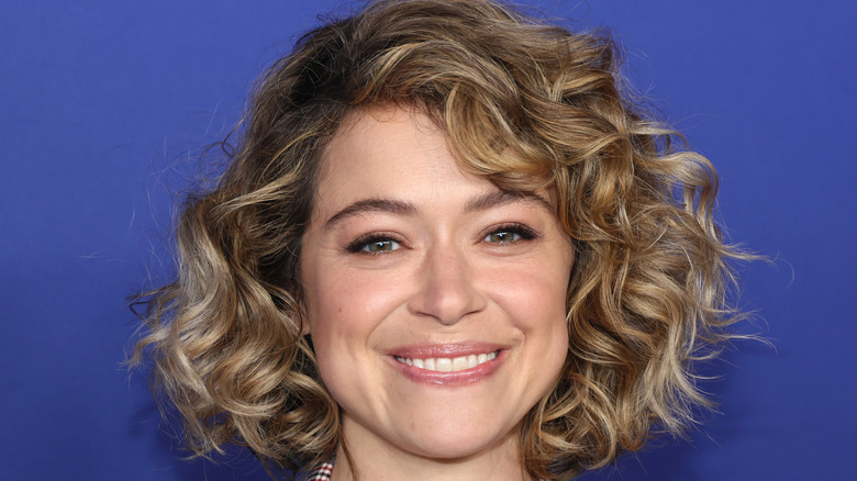 Tatiana Maslany smiling with blonde curls