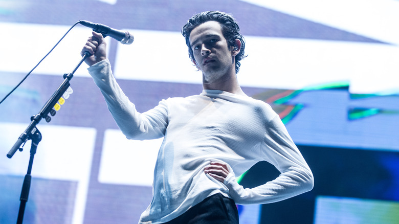 Matty Healy holding a microphone