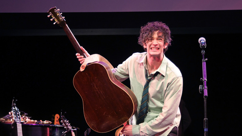 Matty Healy holding a guitar