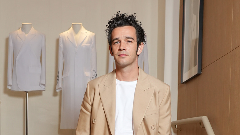 Matty Healy wearing beige overcoat