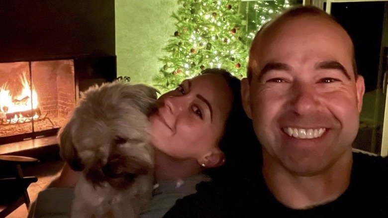 James Murray and Melyssa Davies smiling at Christmas with their dog Penny