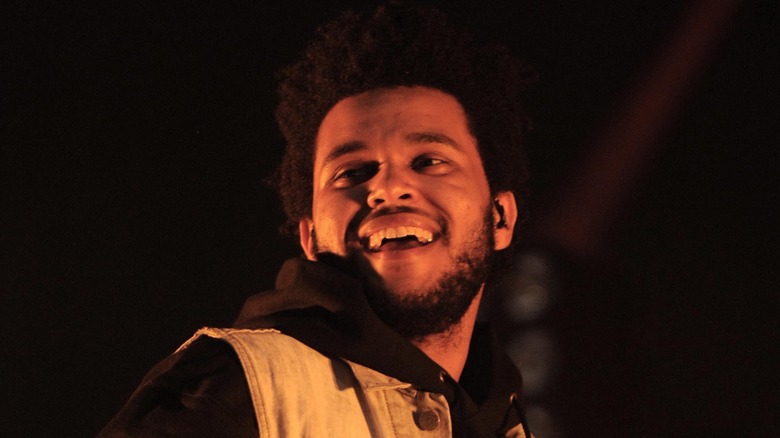 The Weeknd laughing in hoodie