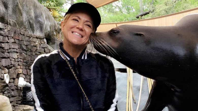 Theresa Caputo being kissed by a seal