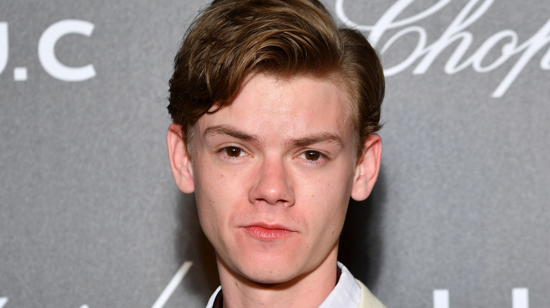 Thomas Brodie-Sangster with a serious expression