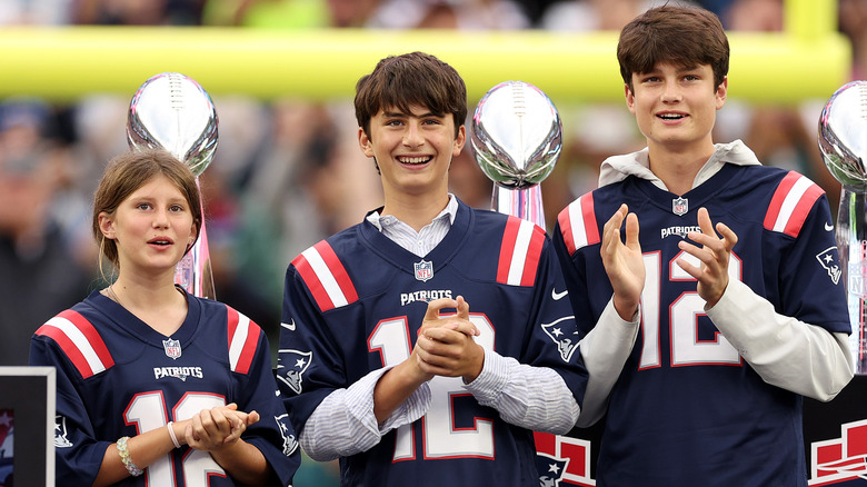 Jack, Vivian, and Benjamin look on during a New England Patriots presentation