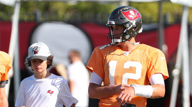 Tom Brady stands next to his son Jack during NFL training camp