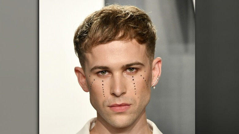 Tommy Dorfman wearing teardrop makeup 