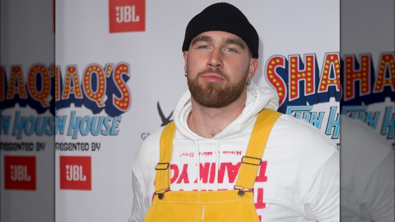 Travis Kelce wearing overalls