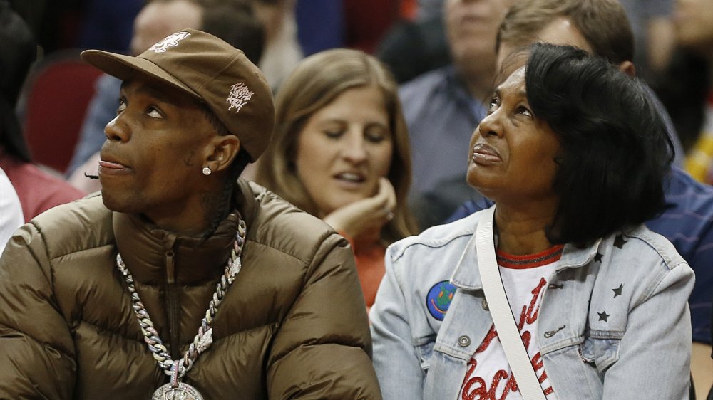 Travis Scott and his mother Wanda Webster courtside 