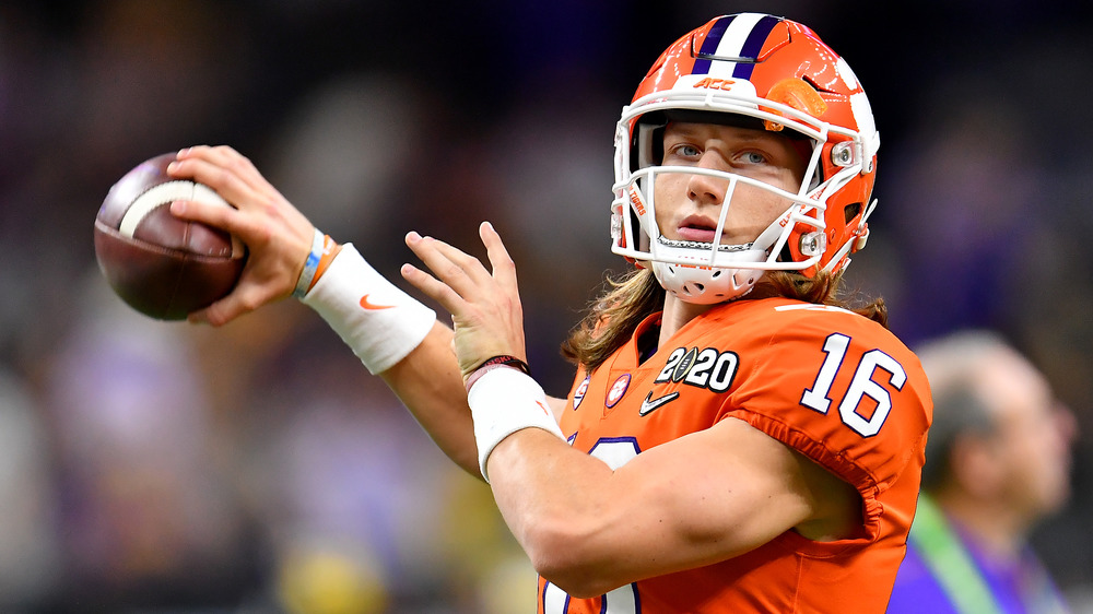 Trevor Lawrence in uniform throwing a football