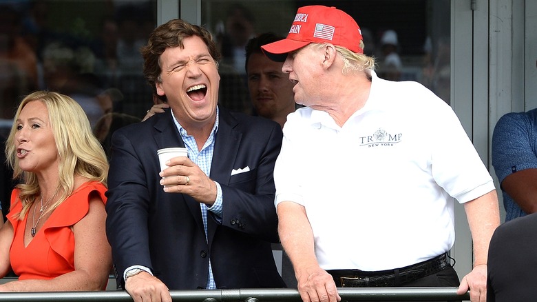 Tucker Carlson laughing with Donald Trump