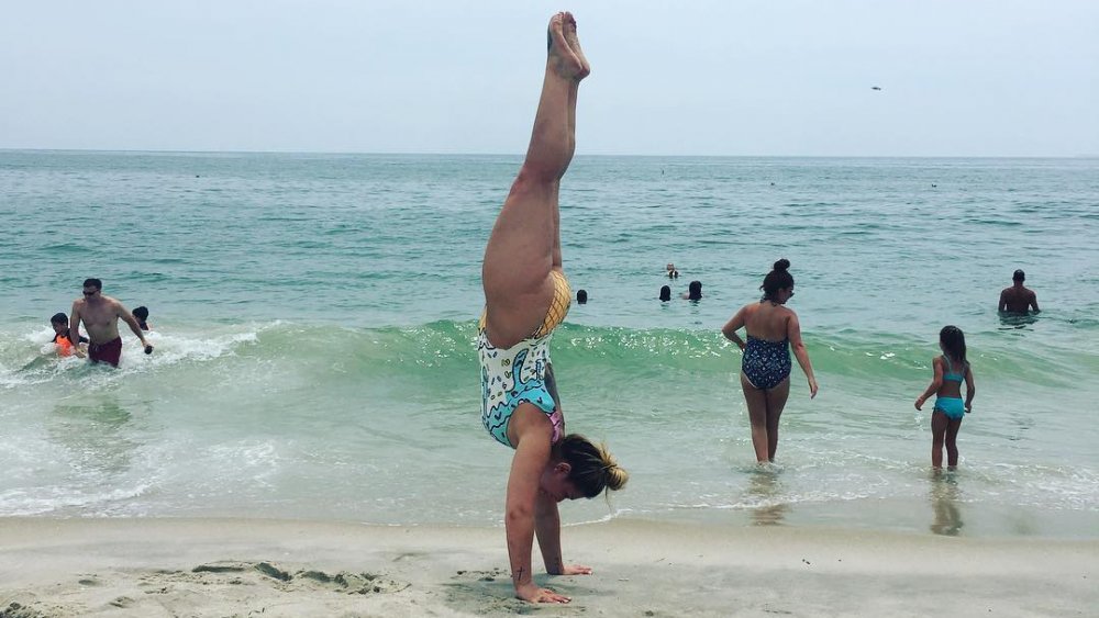 Victoria Caputo doing a handstand on the beach