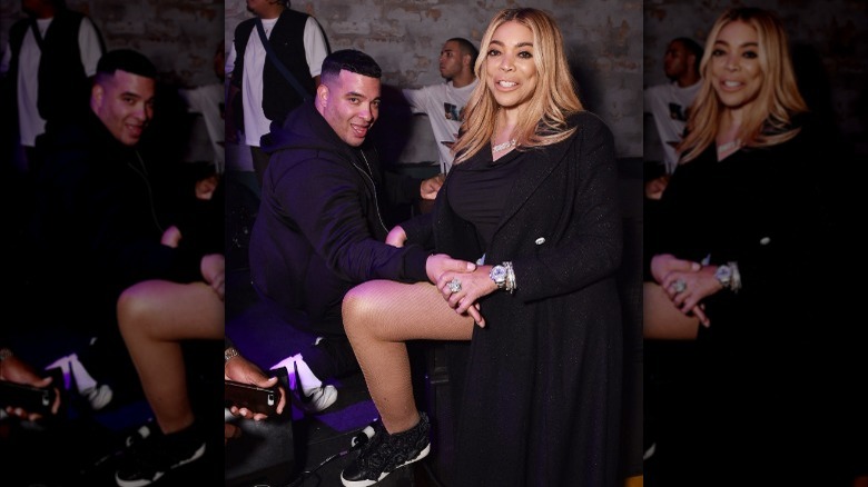 Wendy Williams posing at a Diesel event in sneakers