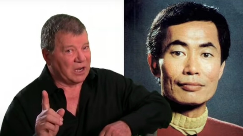 William Shatner sitting in front of George Takei poster