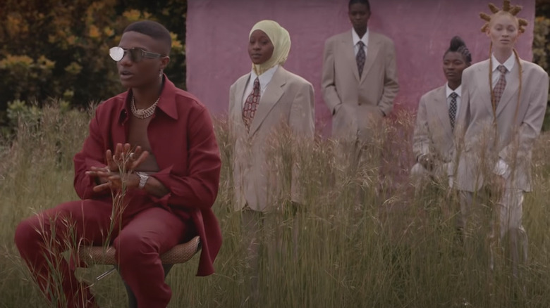 Wizkid seated in chair on the set of Brown Skin Girl