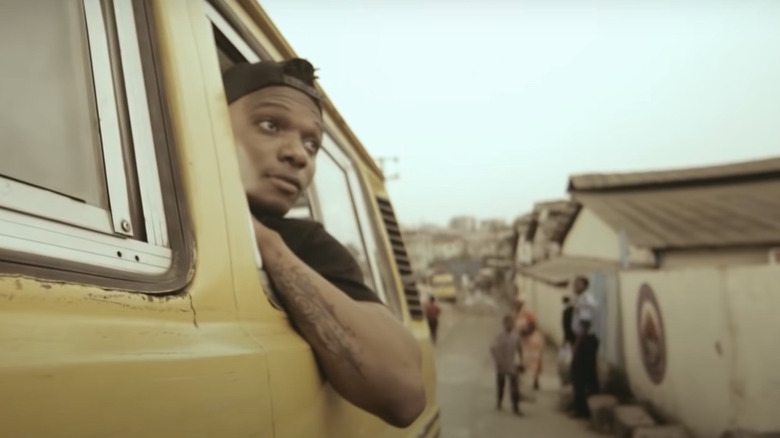 Wizkid with head sticking out of car