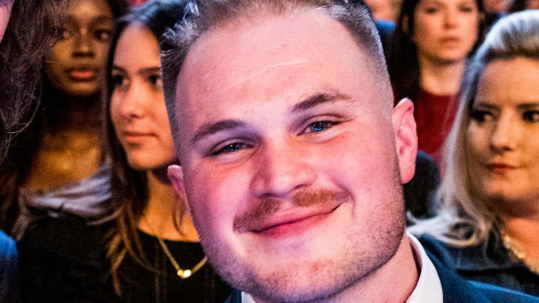 Zach Bryan smiling with fans