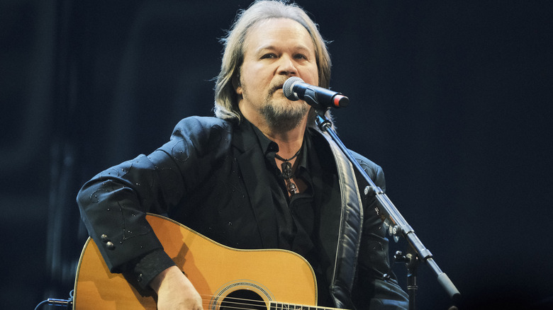 Travis Tritt performing on stage