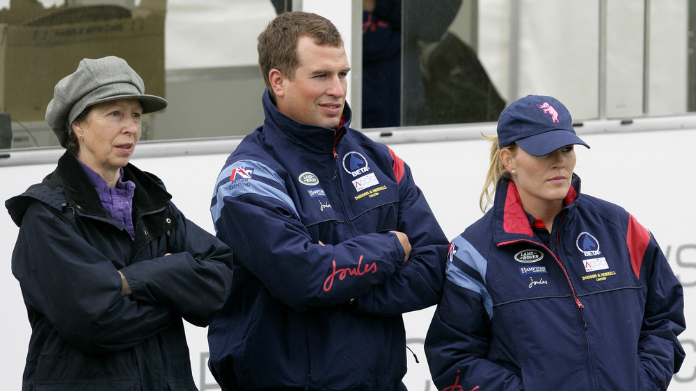 Princess Anne, Peter Phillips, and Autumn Phillips standing together