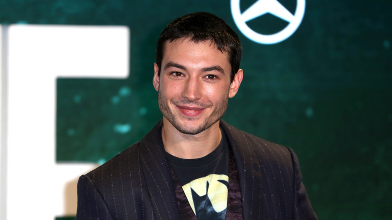 Ezra Miller striped suit jacket smiling