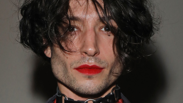 Ezra Miller leather necklace posing