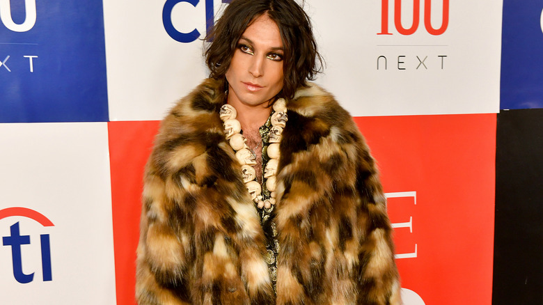 Ezra Miller fur skull necklace posing