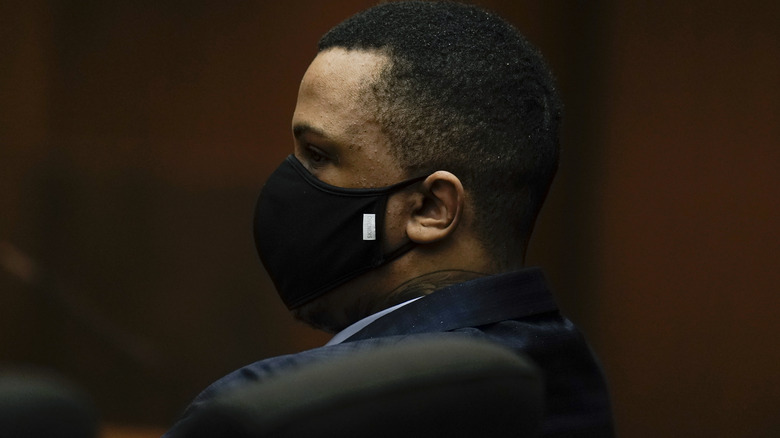 Eric Holder Jr., who is accused of killing rapper Nipsey Hussle, sits in a courtroom to hear the verdict