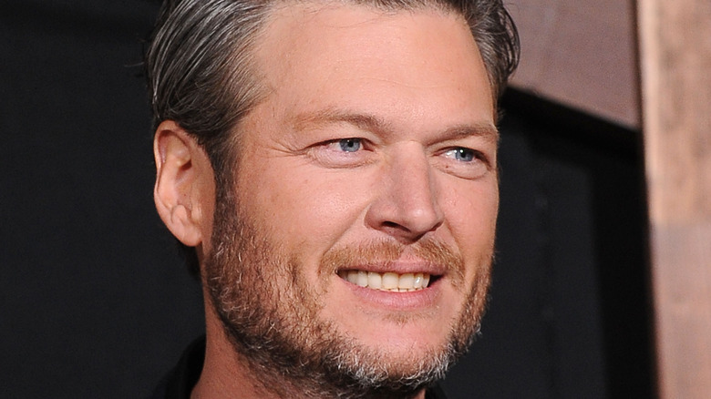 Blake Shelton smiles at an event