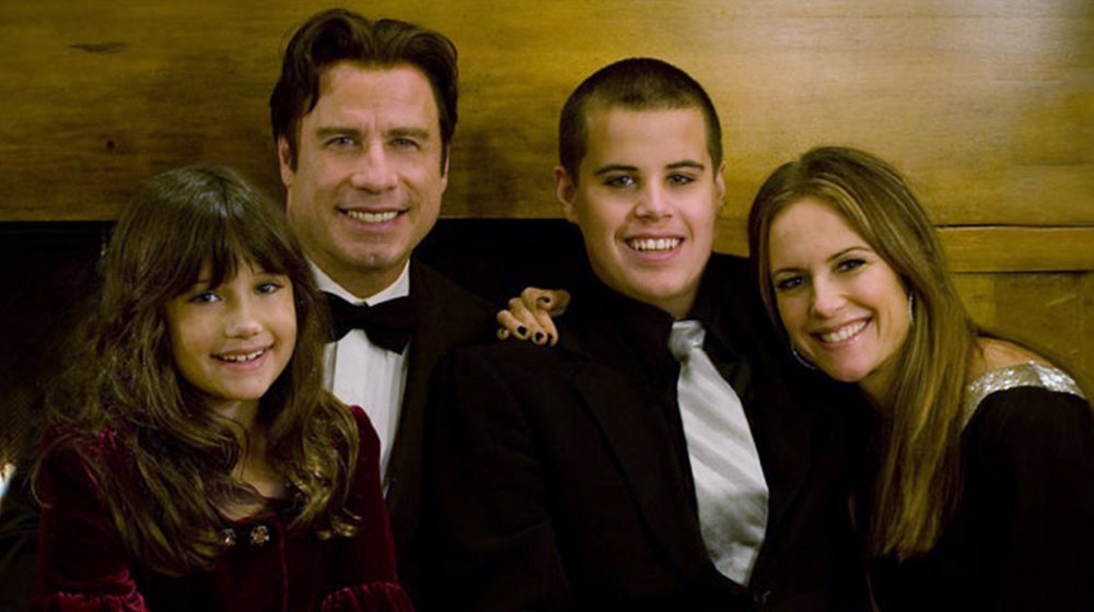 Ella Travolta, John Travolta, Jett Travolta, and Kelly Preston posing together at a formal event 