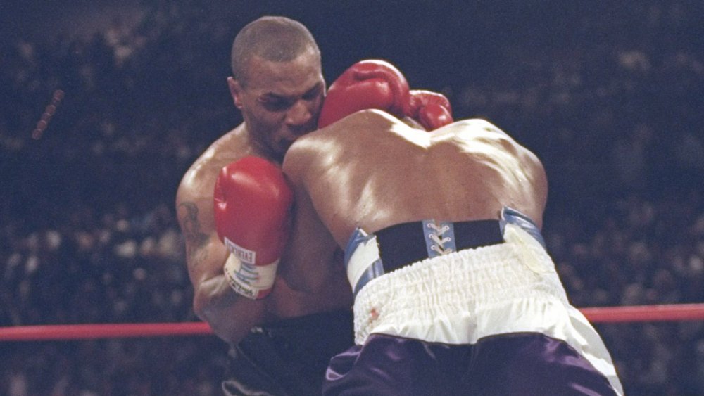 Mike Tyson biting Evander Holyfield's ear off